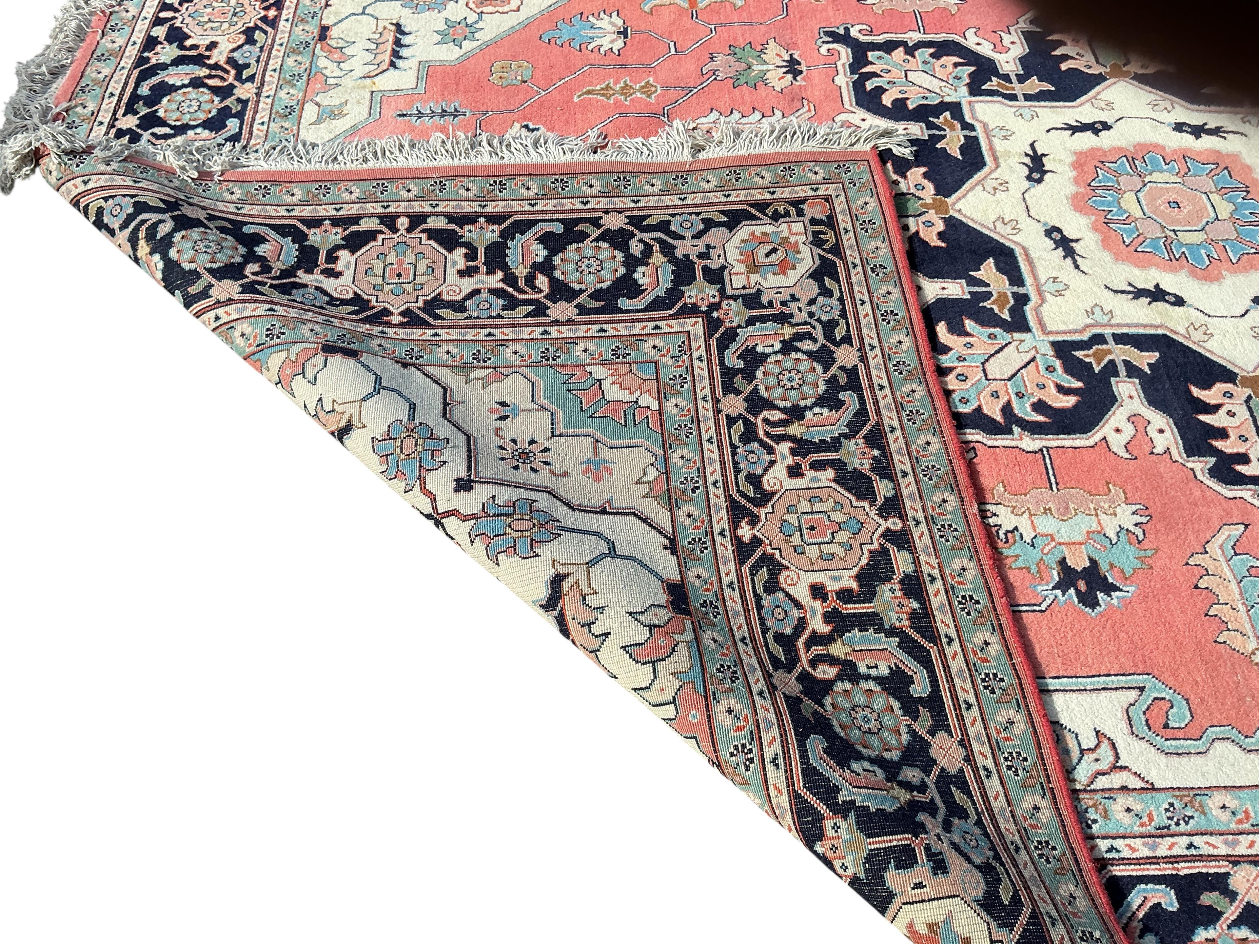 A Heriz brick red ground carpet, 360 x 266cm